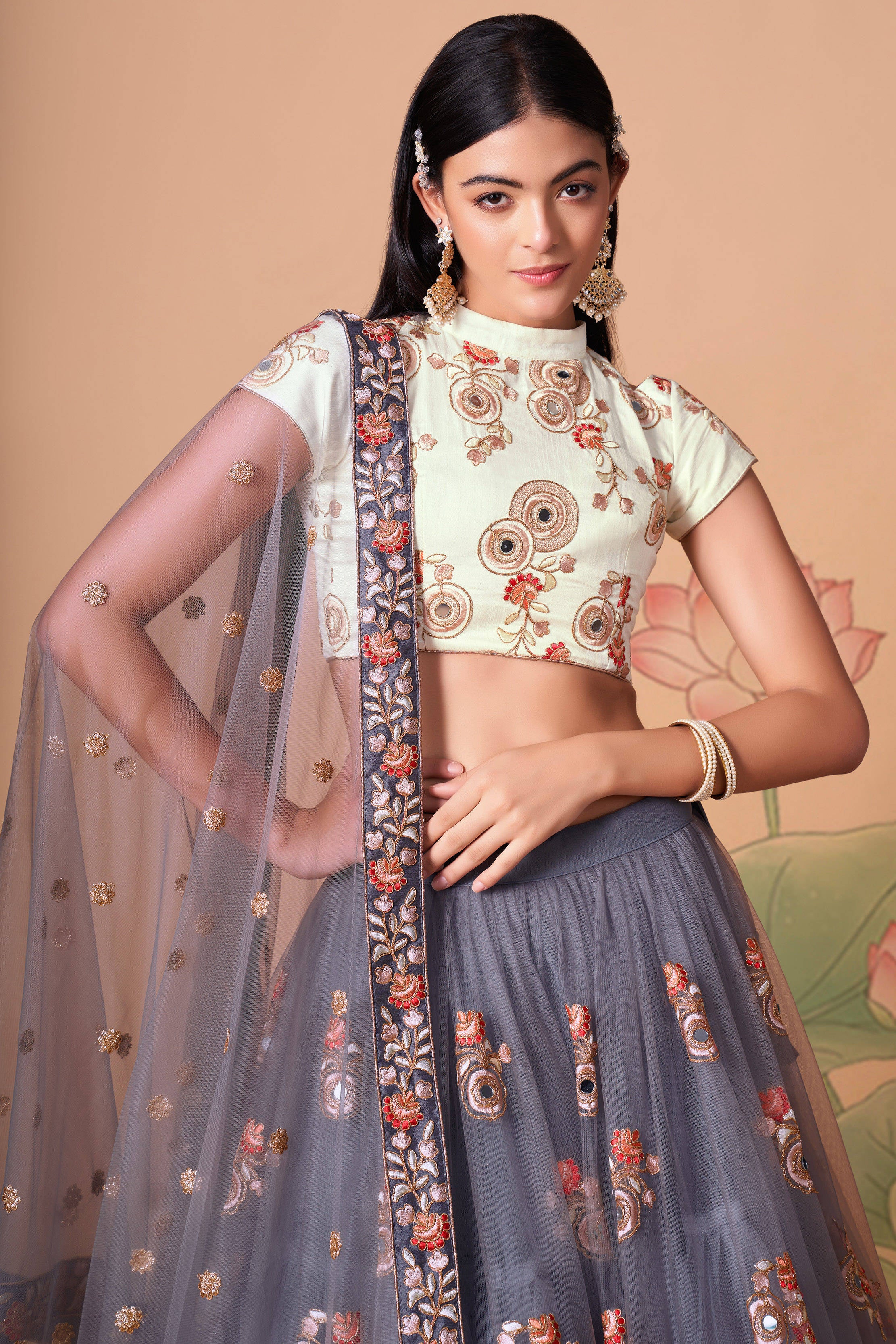 The grey color net dupatta comes prettified with thread embroidery and sequin work.